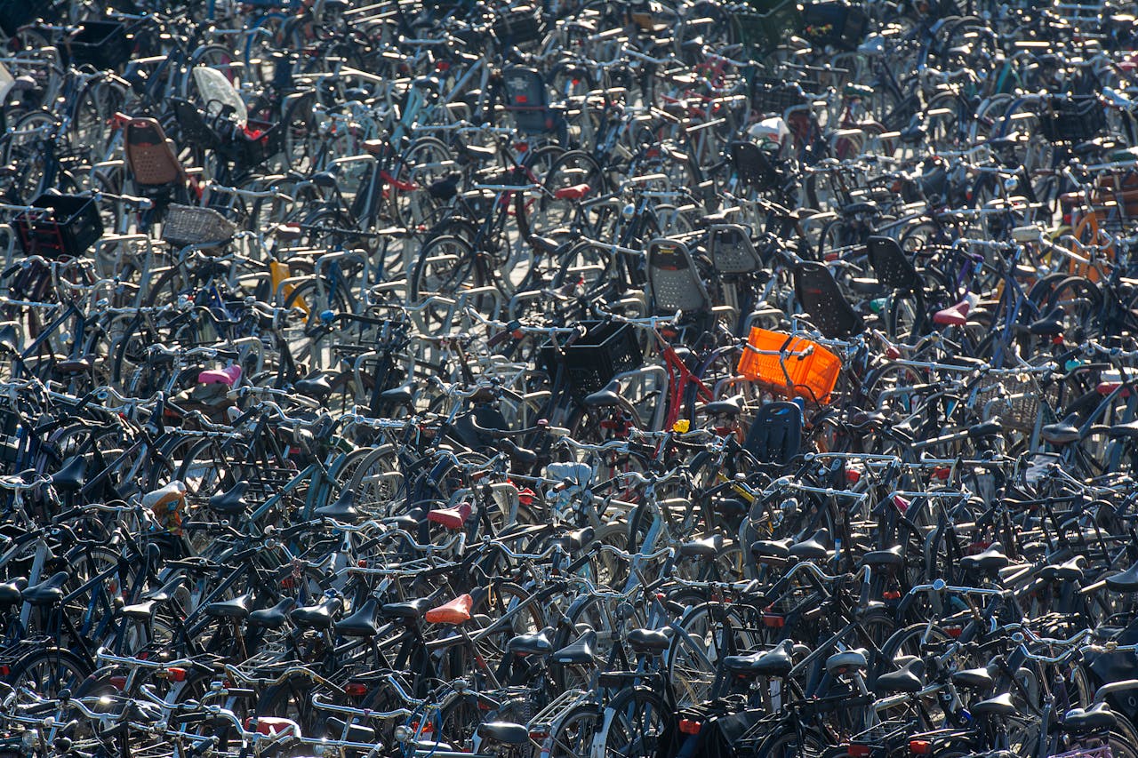 gallery-4 Overhead view of a densely packed bicycle parking area with numerous bikes in various styles and colors.