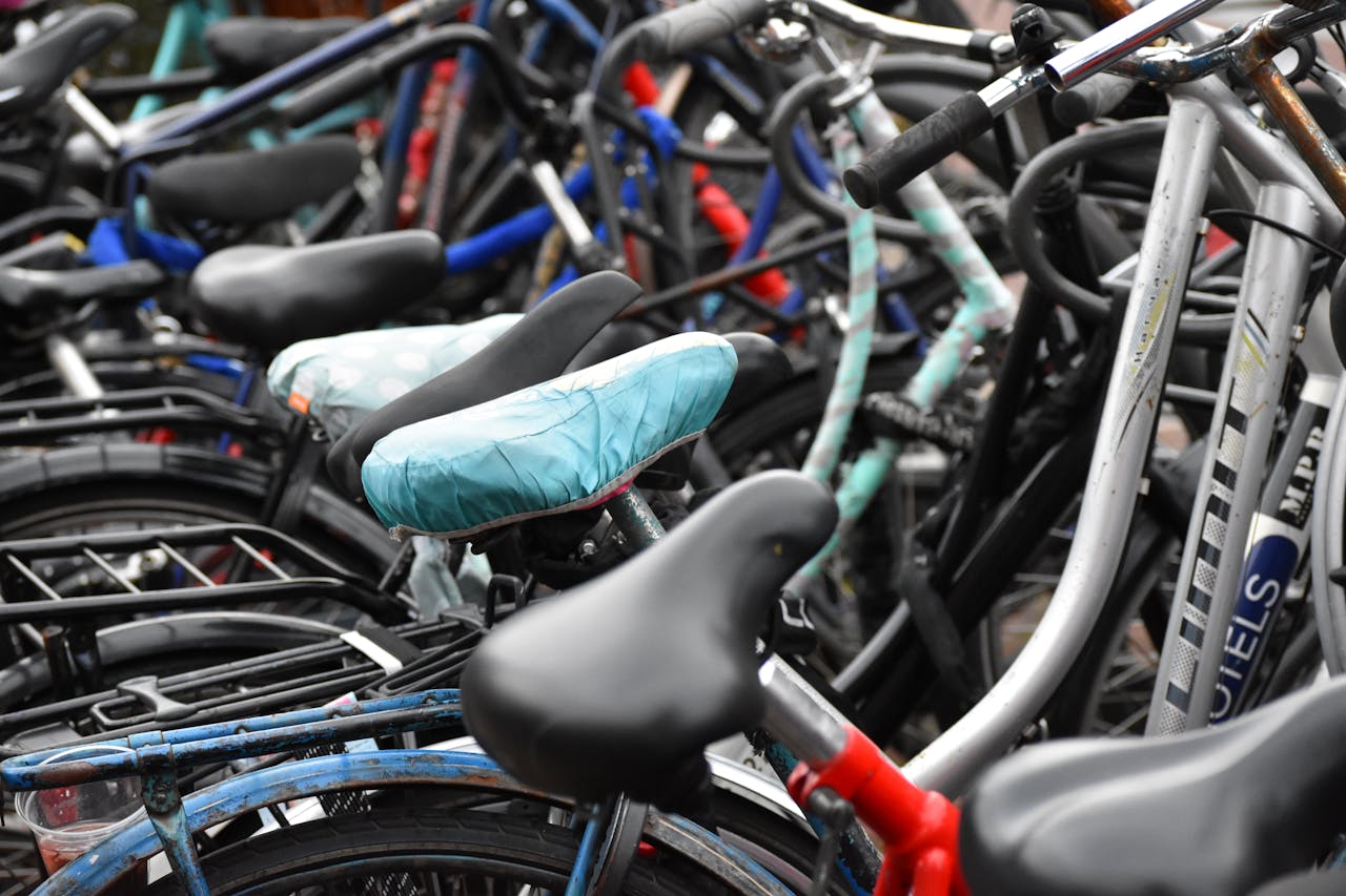 Vibrant collection of bicycles with colorful seats captured in an Amsterdam street.